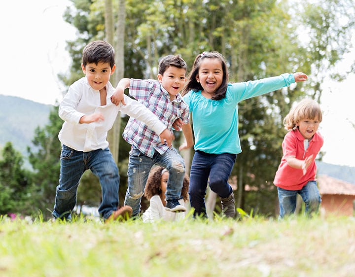 A group of children running outside