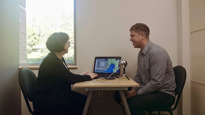 A health care professional helping a patient with a voice disorder