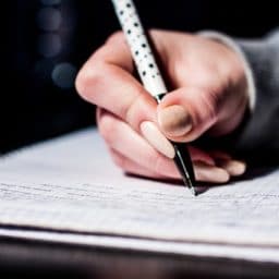 woman taking a test on paper