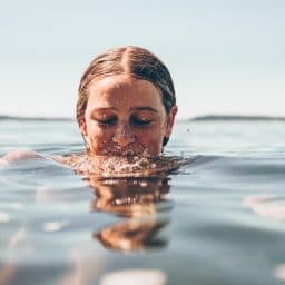 woman with her head halfway in water