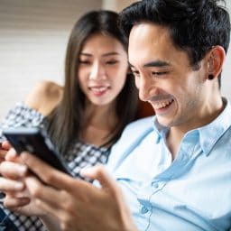 A woman and a man with hearing aids relaxing.