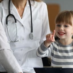 Young girl sitting with a doctor.