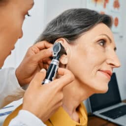 Woman having her ear examined