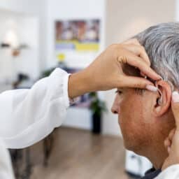 Senior man getting a new hearing aid